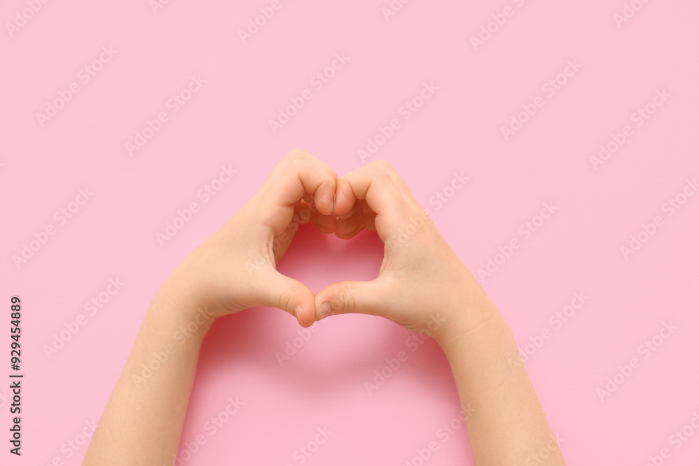 Fototapeta premium Child making heart with hands on pink background, closeup