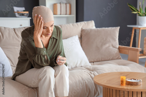 Mature woman after chemotherapy with weed sitting on couch at home