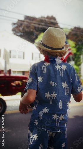 Young Boy Waving American Flag With Tractor Passing By In Parade