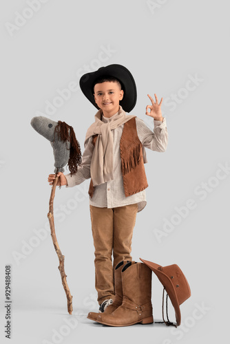 Cute little cowboy with toy...