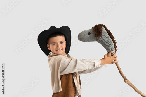 Cute little cowboy with toy...