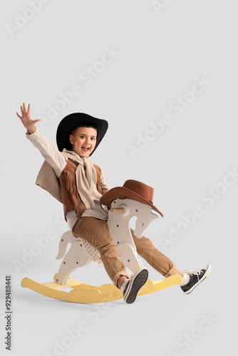 Cute little cowboy on rocki...
