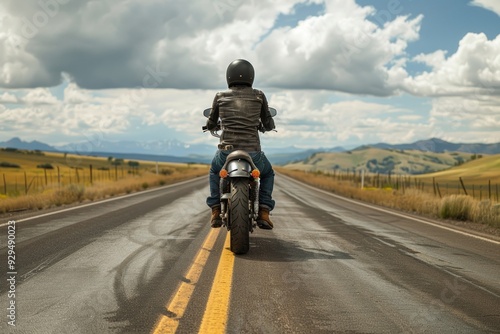 Wallpaper Mural A person rides a motorcycle down a winding road, with a scenic backdrop Torontodigital.ca