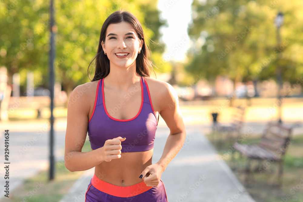 Sporty young woman jogging in park Sporty young woman jogging in park