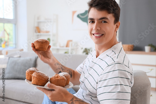 Young man with tasty muffin...