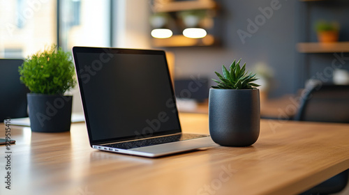 Wallpaper Mural A laptop sits on a wooden desk next to a potted plant in a modern, minimalist workspace, creating a productive and calming environment. Torontodigital.ca