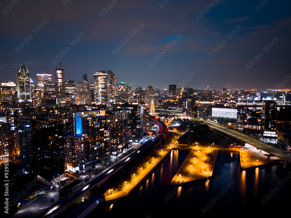 Montreal skyline illuminated at dusk and reflected in the water, Quebec, Canada Montreal skyline illuminated at dusk and reflected in the water, Quebec, Canada