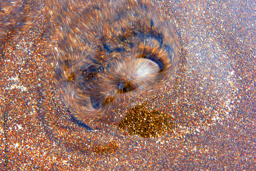 Long exposure and top angle view of fresh water eruption on sand at Samyang Beach of Jeju-si near Jeju-do, South Korea  photo