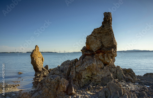 Danwon-gu, Ansan-si, Gyeonggi-do, South Korea - May 20, 2018: Afternoon view of grandmother and grandfather rocks with the background of Yeongheung Bridge on the sea at Gubongdo Island photo