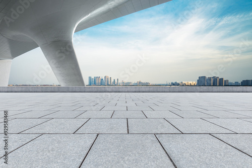 Empty square floor and city skyline with modern buildings.