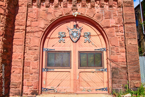 Ornate Medieval Wooden Door with Heraldic Lions Eye-Level Perspective photo