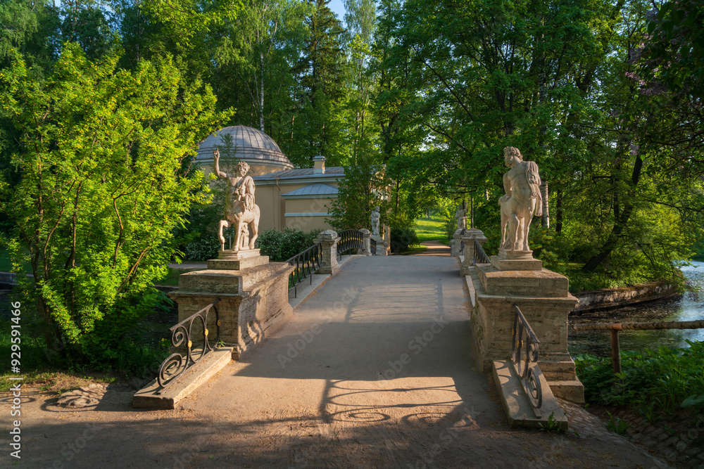 View of the Centaur Bridge over the Slavyanka River in the Pavlovsky Palace and Park Complex on a sunny summer day, St. Petersburg, Russia