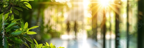 Blurred background of people walking in a modern office building with green trees and sunlight , eco friendly and ecological responsible business concept image with copy space