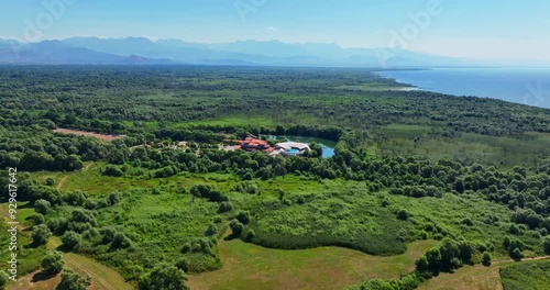 Panoramic drone shot circling the Plavnica Eco Resort, in Skadar lake, Montenegro photo