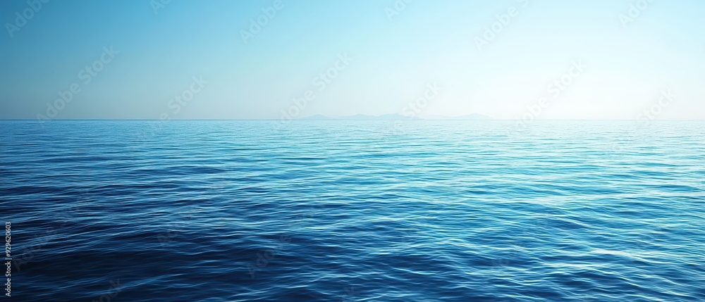 Fototapeta premium A tranquil blue ocean scene with soft waves and a clear sky