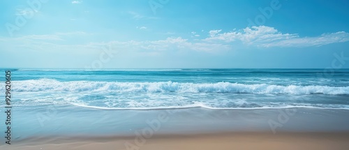 A tranquil blue ocean scene with soft waves and a clear sky