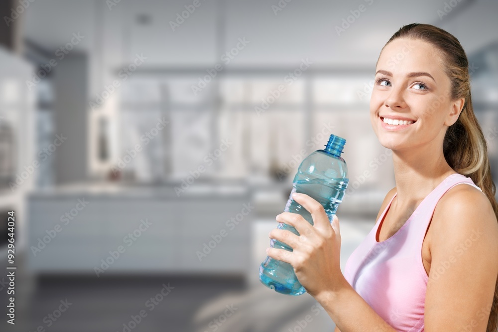 A young pretty woman drinking water at kitchen A young pretty woman drinking water at kitchen