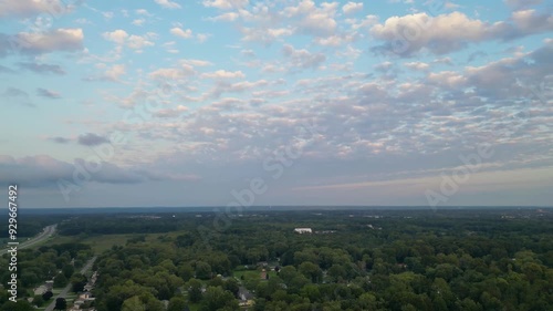 Wallpaper Mural A serene rural landscape under a dusk sky filled with scattered clouds. This tranquil scene captures the peacefulness of the countryside. Torontodigital.ca