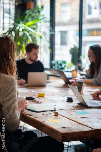 A creative agency team presenting a pitch to clients in a modern boardroom