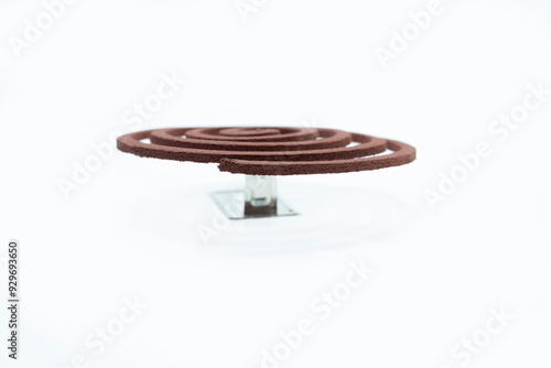 A mosquito coil with smoke coming out of it photo