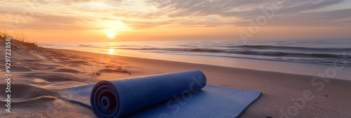 Yoga mat on serene beach at sunrise photo