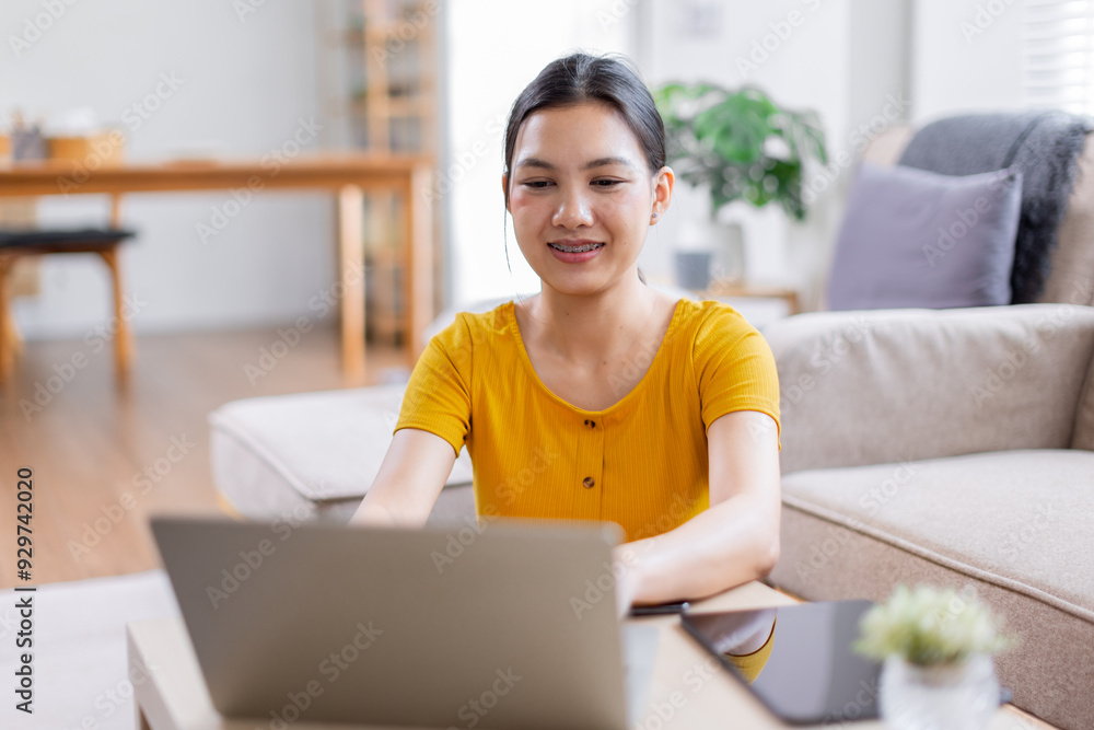 Portrait of a young happy asian female freelancer sitting on the couch and working on project, watching movie on laptop, studying, blogging, resting and chatting online.
Portrait of a young happy asian female freelancer sitting on the couch and working on project, watching movie on laptop, studying, blogging, resting and chatting online.
