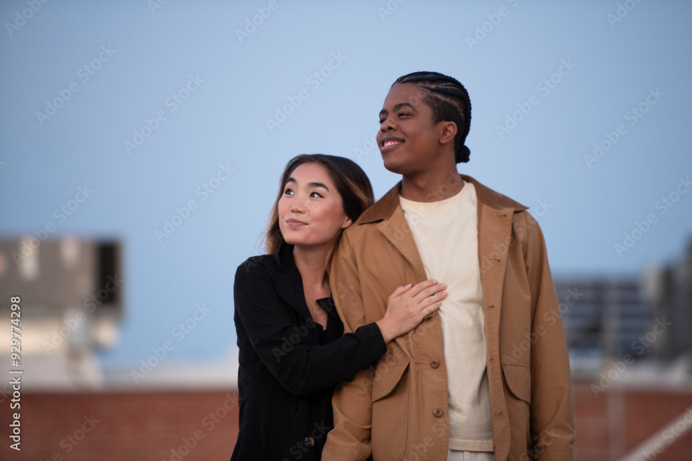 Muti racial couple share a moment together on an urban roof-top Muti racial couple share a moment together on an urban roof-top