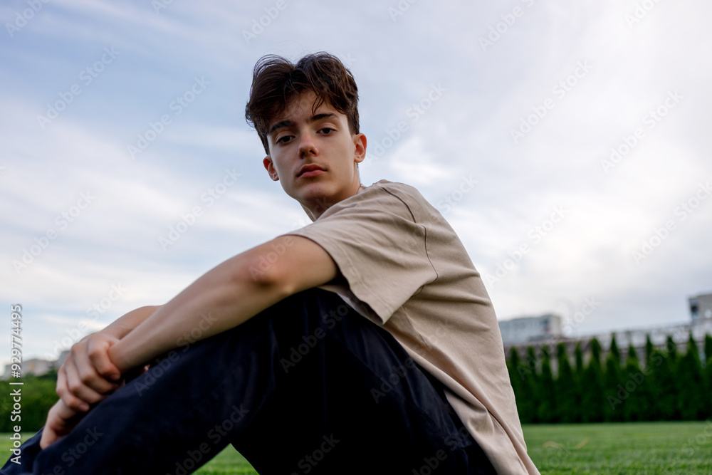 Teenager enjoying quiet time on the grass Teenager enjoying quiet time on the grass