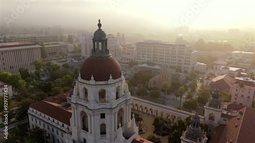 This breathtaking aerial view captures Pasadena City Hall in all its glory, showcasing the iconic architecture and the beautiful surrounding cityscape, all set against a misty and enchanting backdrop