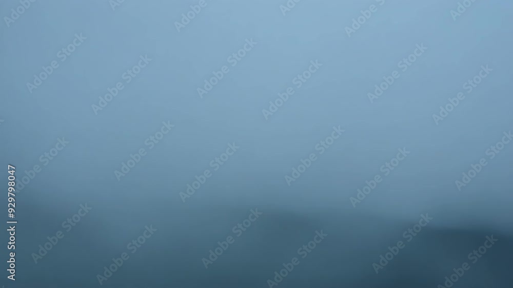 Rising fog creates spooky halloween atmosphere, blending dark tones with shades of gray, blue, and white for a blurred, abstract look. Perfect for chilling designs Rising fog creates spooky halloween atmosphere, blending dark tones with shades of gray, blue, and white for a blurred, abstract look. Perfect for chilling designs