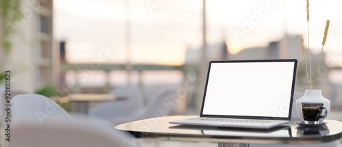 Wallpaper Mural A laptop computer with a white-screen mockup on a table in a modern cafe sitting area. Torontodigital.ca