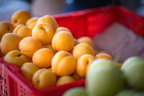 Peach fruit in red basket on wooden table in market. photo