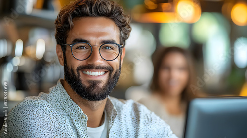 A smiling man with glasses ...