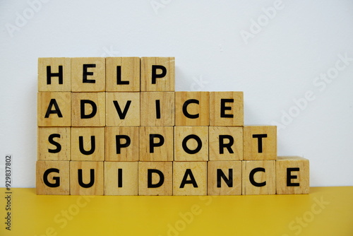 Help, Advice, Support, Guidance with wooden blocks alphabet letterstop view on wooden background photo