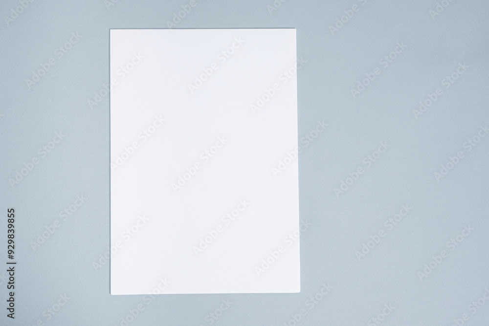 Blank Sheet of Paper on Blue Background, Top View, Space for Text Blank Sheet of Paper on Blue Background, Top View, Space for Text
