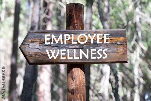 EMPLOYEE WELLNESS written on a wooden signpost against a forest background