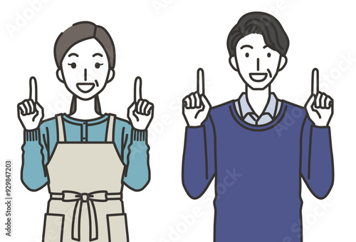 上を指さす40代か50代の男性と女性