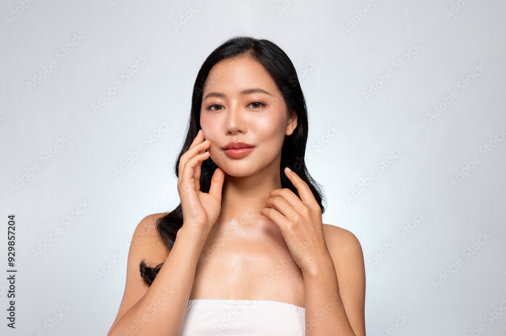 A young Asian woman with perfect beauty face, long hair, and healthy tanned skin portrait. A young Asian woman with perfect beauty face, long hair, and healthy tanned skin portrait.