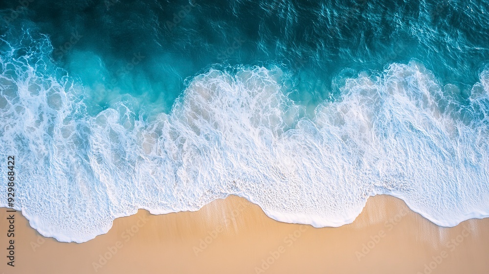 An aerial photograph of gentle waves crashing on a sandy beach, creating a beautiful pattern of white foam against the turquoise water An aerial photograph of gentle waves crashing on a sandy beach, creating a beautiful pattern of white foam against the turquoise water