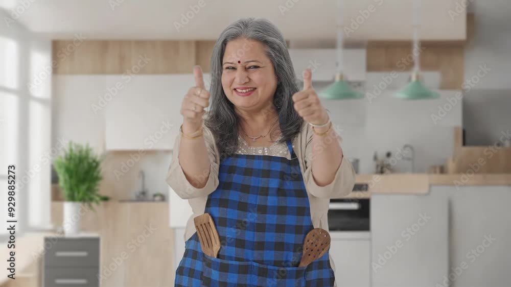 Happy Indian aged housewife showing thumbs up Happy Indian aged housewife showing thumbs up