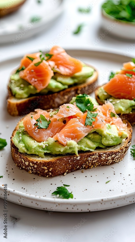 Toast with advocado cream and salmon, on a white plate. healthy snack. Toast with advocado cream and salmon, on a white plate. healthy snack.