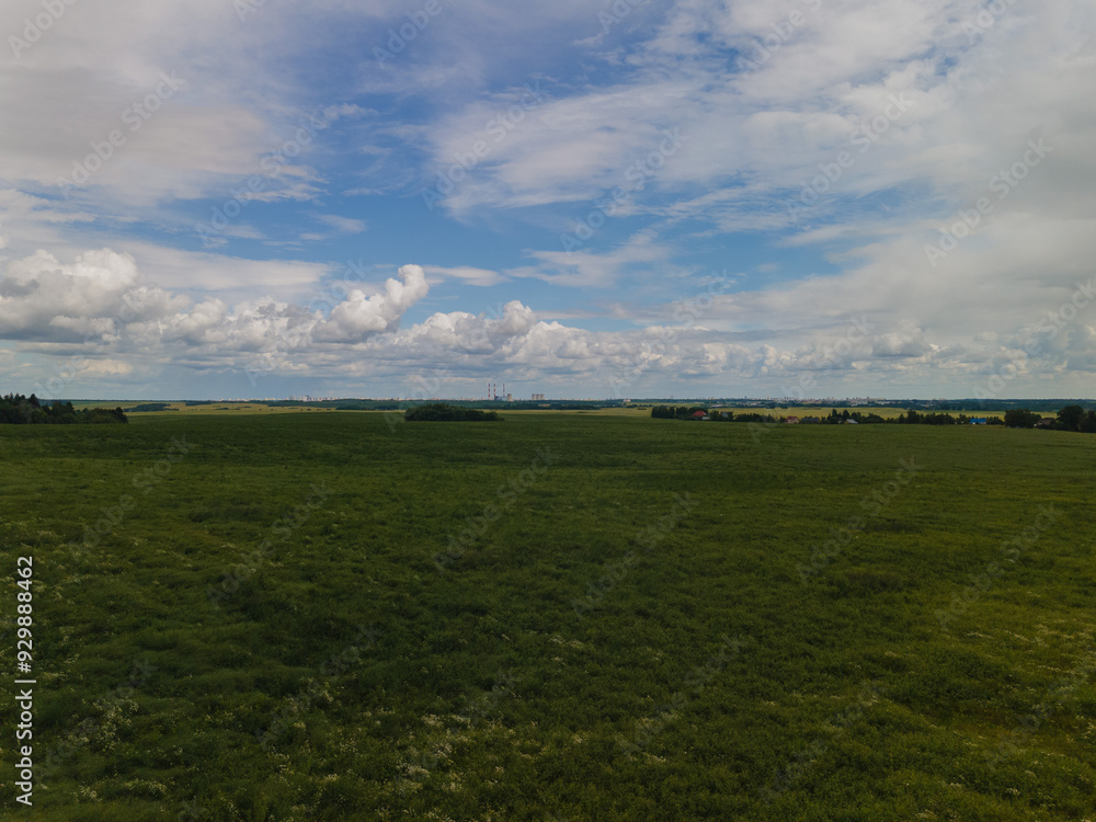 Drone view of the highway road, forest and fields, top view and blue sky