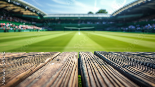 Empty tennis court with a wooden platform in the foreground during a sunny day