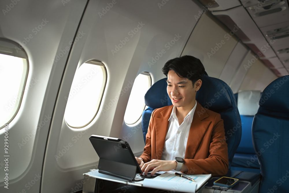 Successful businessman in elegant suit working with digital in aircraft during business travel Successful businessman in elegant suit working with digital in aircraft during business travel
