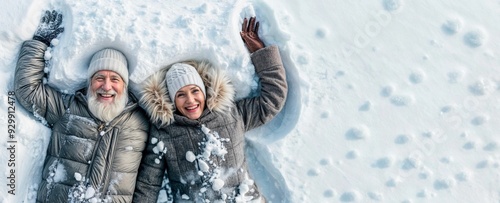 Winter senior couple making snow angel. Happy old woman and man. Mature family laying outside. Cold people, active fun and walk on winter holiday. Elderly couple on nature. Healthy sport relax banner