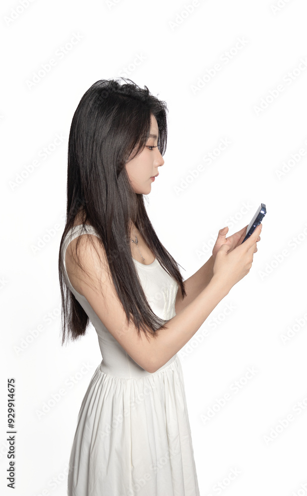 Oriental female young beauty using mobile phone in front of white background Oriental female young beauty using mobile phone in front of white background
