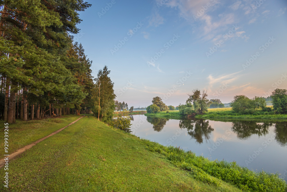 A peaceful scene of a river with trees in the background A peaceful scene of a river with trees in the background