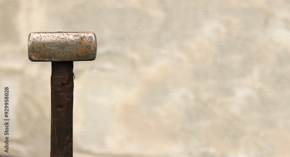 Sledgehammer on a blurred background. Close-up of a two-handed heavy hammer. Hand tools for repair and construction. Close-up of a sledgehammer for repair work Sledgehammer on a blurred background. Close-up of a two-handed heavy hammer. Hand tools for repair and construction. Close-up of a sledgehammer for repair work