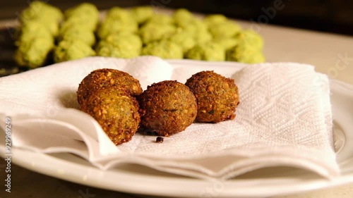 Fresh deep fried falafel lies on a napkin. 4k video, close angle