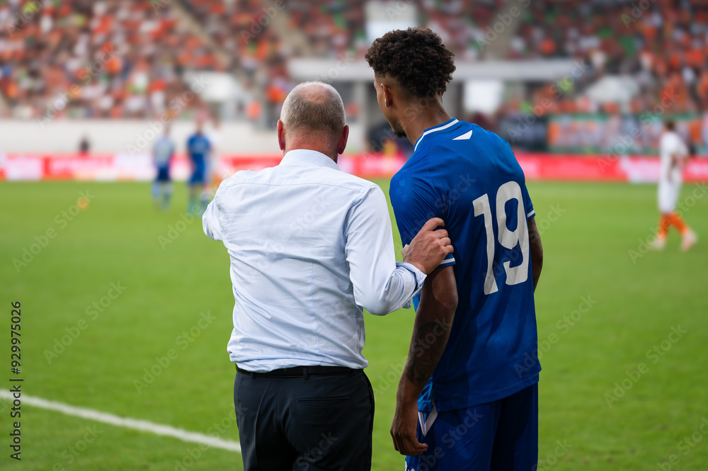 Soccer head coach gives instruction to substitute player